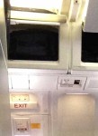 Upper panel loose above right side emergency exit (above row 19)